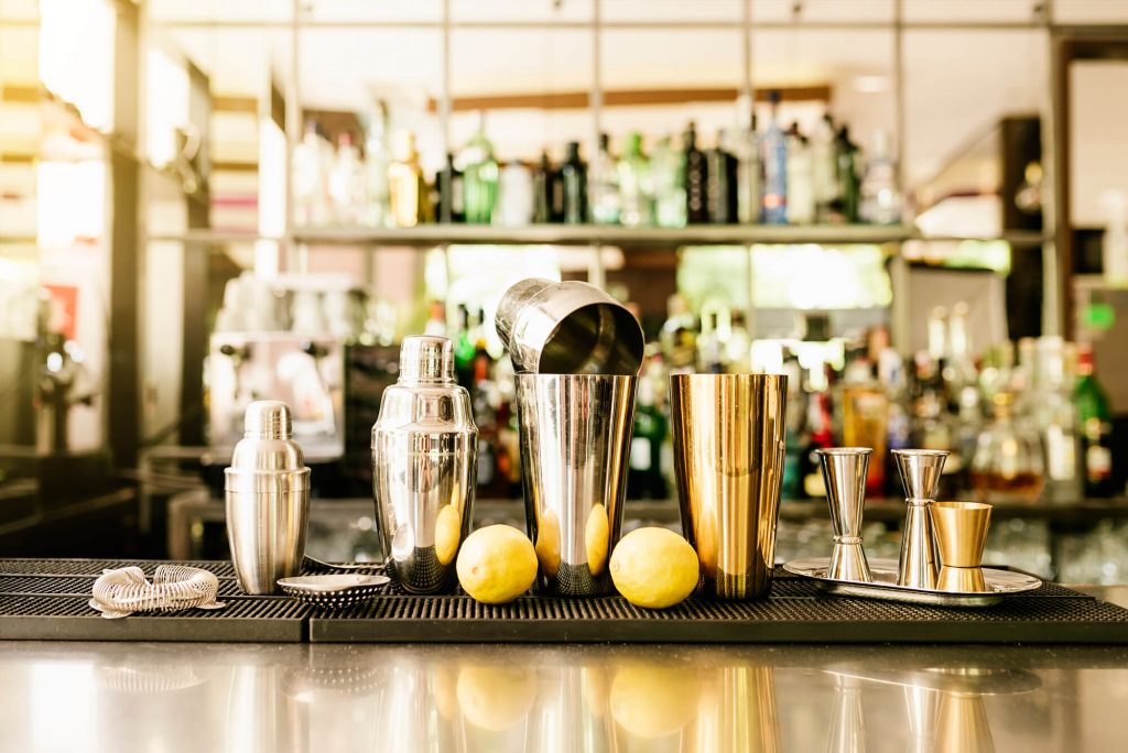 Cocktail shaker in a bar setup