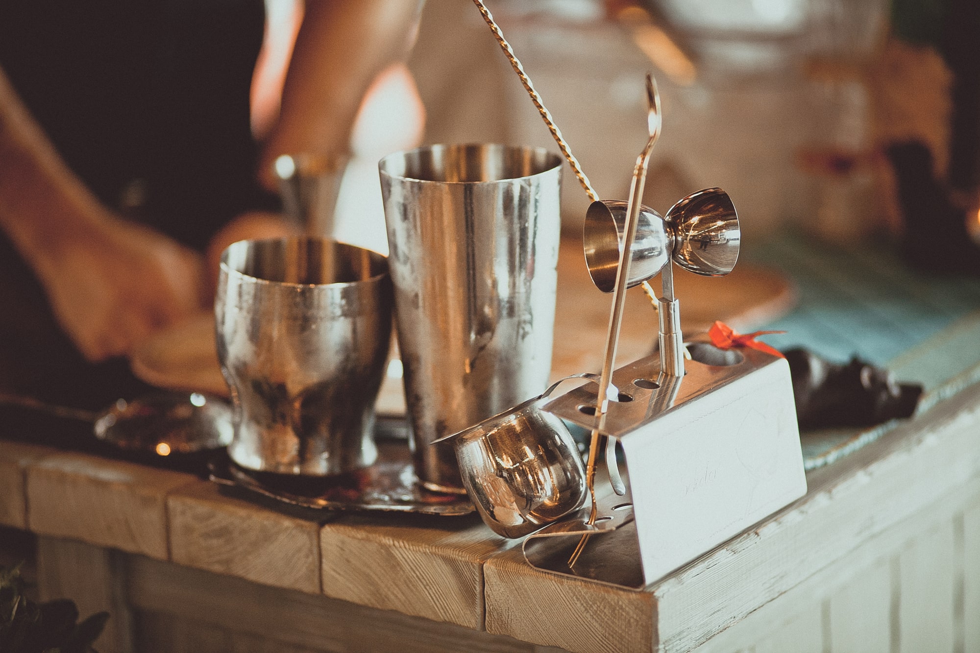 Bartender equipment cocktail shaker and spoons on the bar