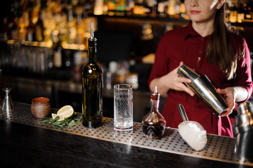Bar attendant holding professional cocktail shaker