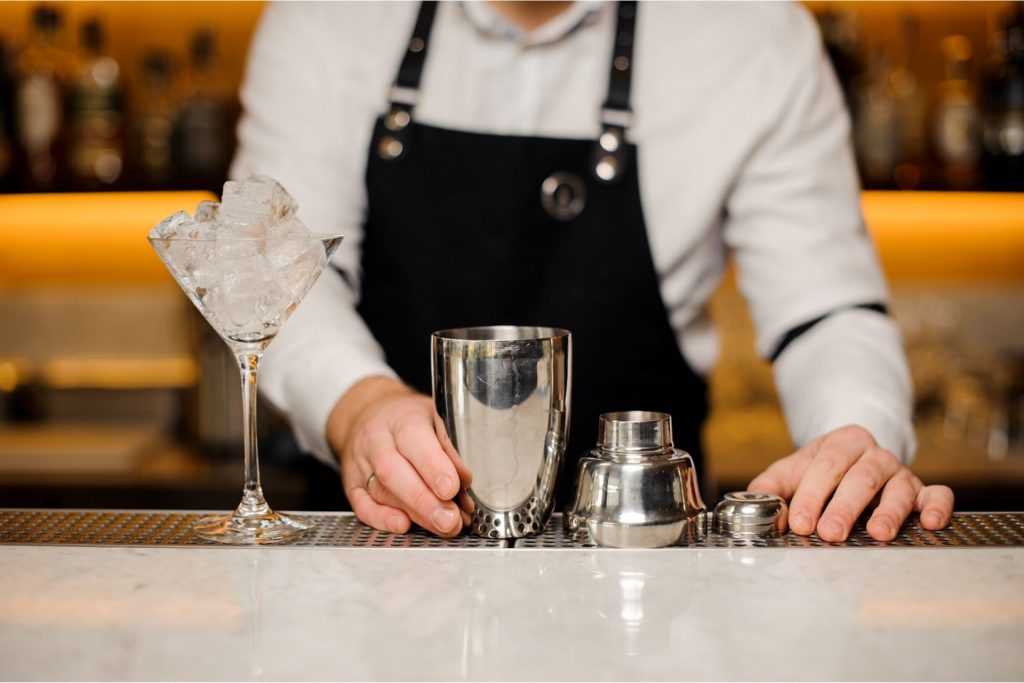Bartender mixing a cocktail with mixology kit as the perfect gifts for bartenders
