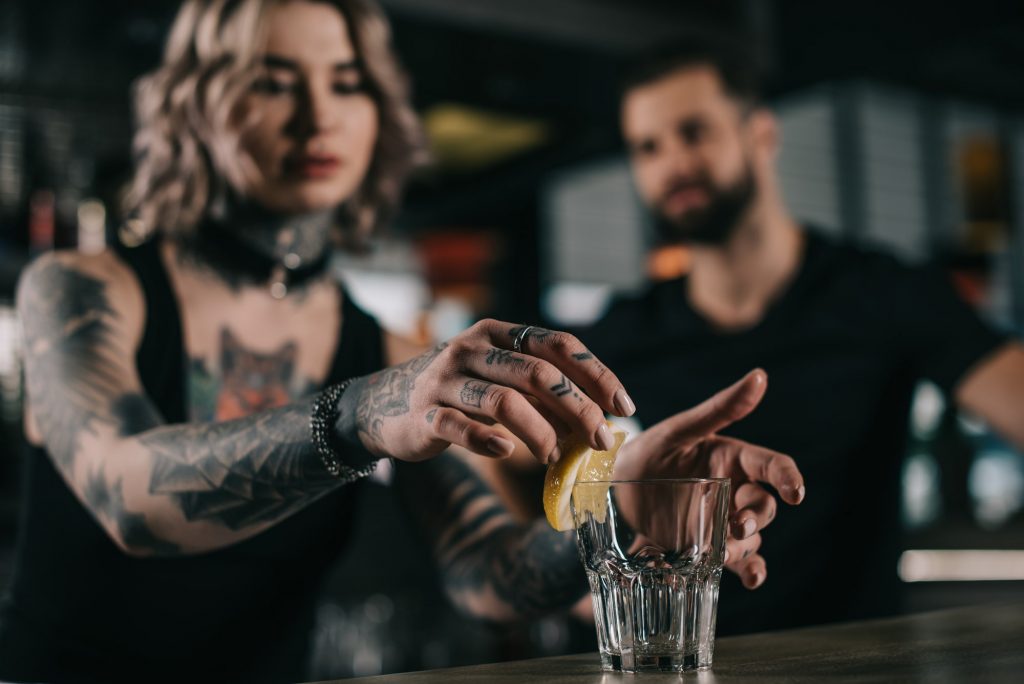 Beginner bartender practising techniques and mixology terms