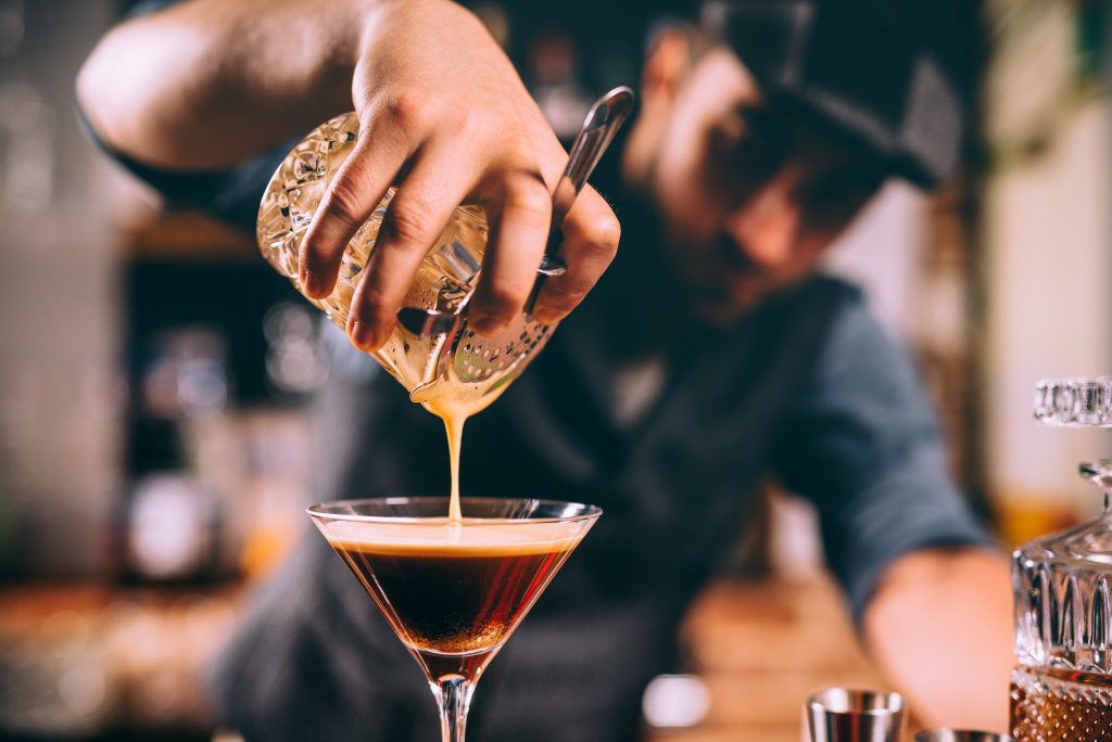 Bartender using Hawthorn drink strainer