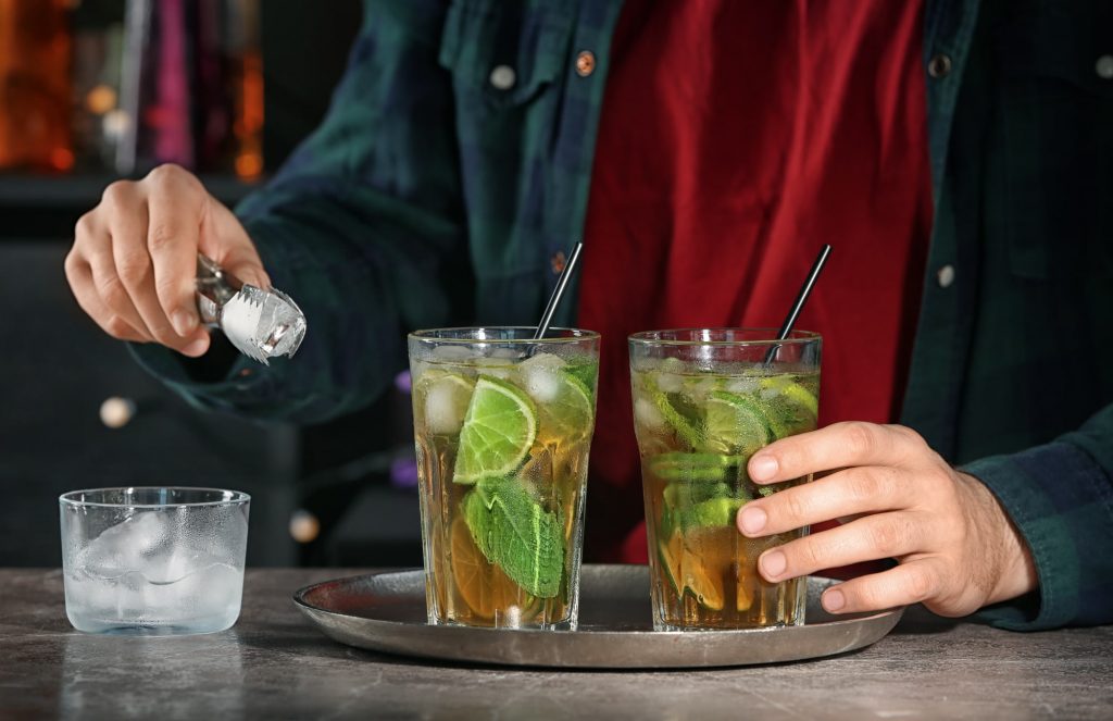 Bartender preparing mint julep cocktail with mixology basics