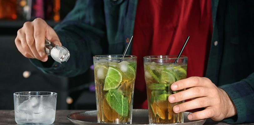 Bartender preparing mint julep cocktail with mixology basics