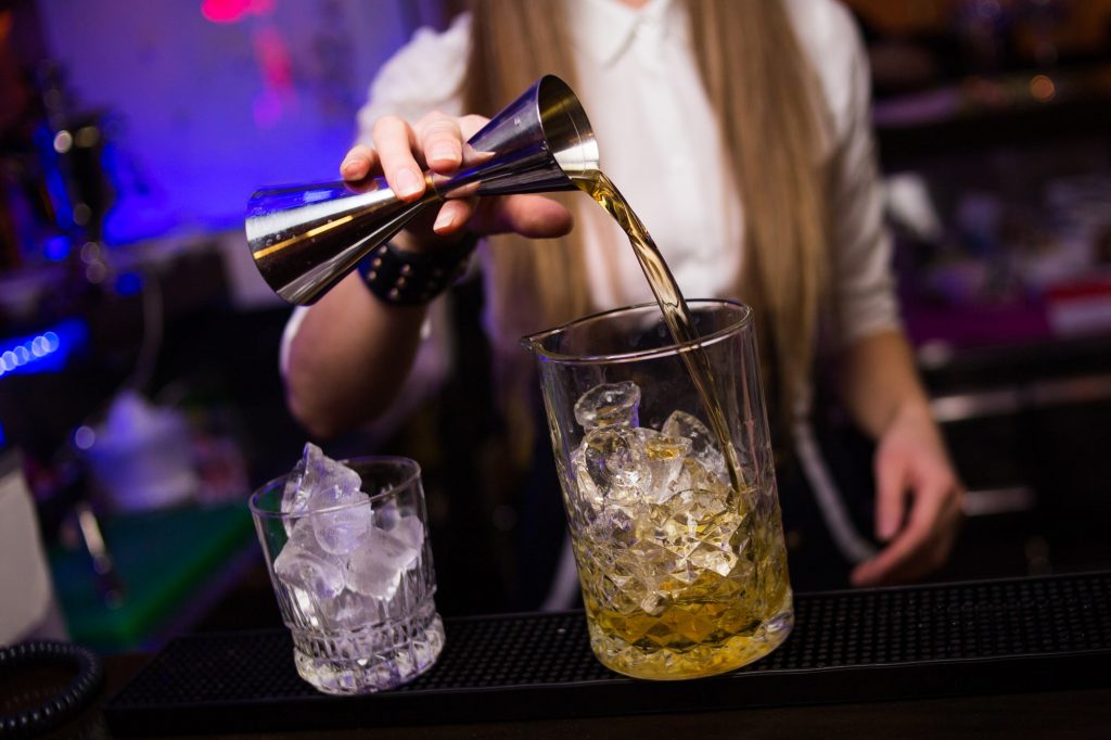 Photo of a bartender pouring a drink